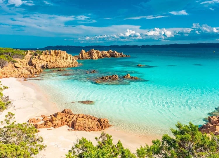 Secluded beach with brilliant blue sea along a coastal cycling path